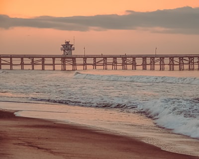 Brown wooden dock at sea during the day
